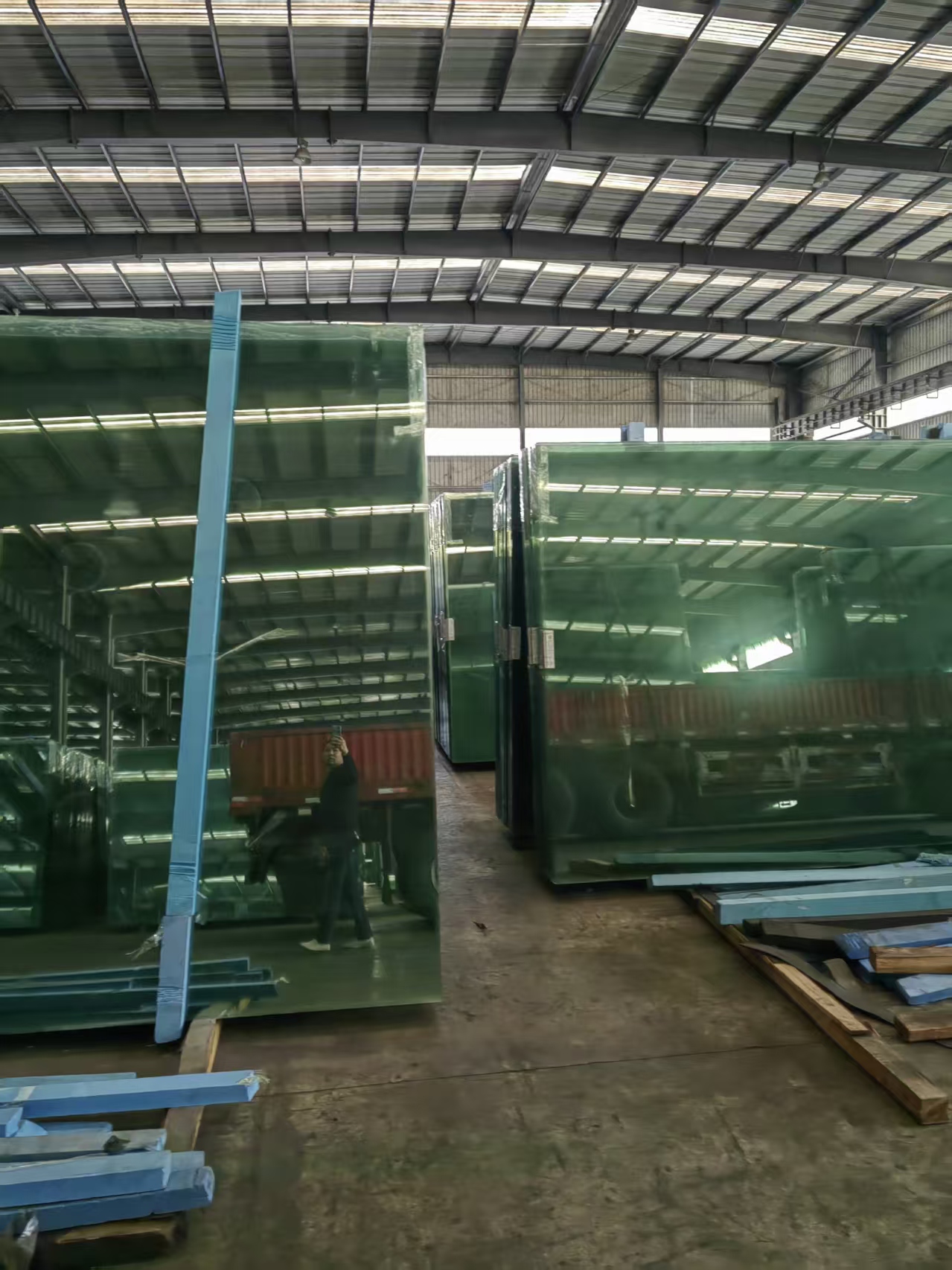 双宇伟业玻璃加工车间一角，工人正在进行玻璃精细加工